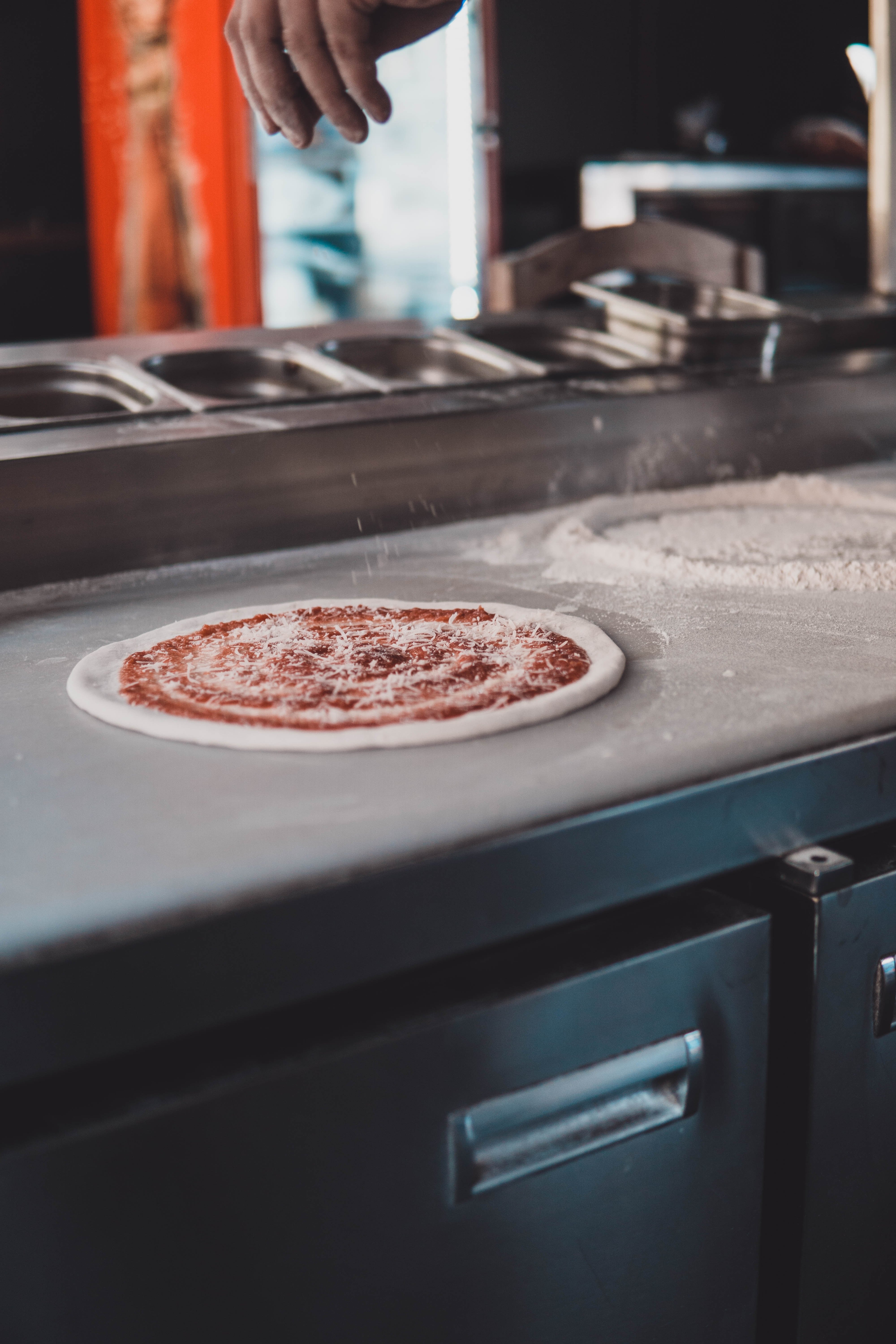 Mother making pizza | Photo by Vaishnav Chogale on Unsplash