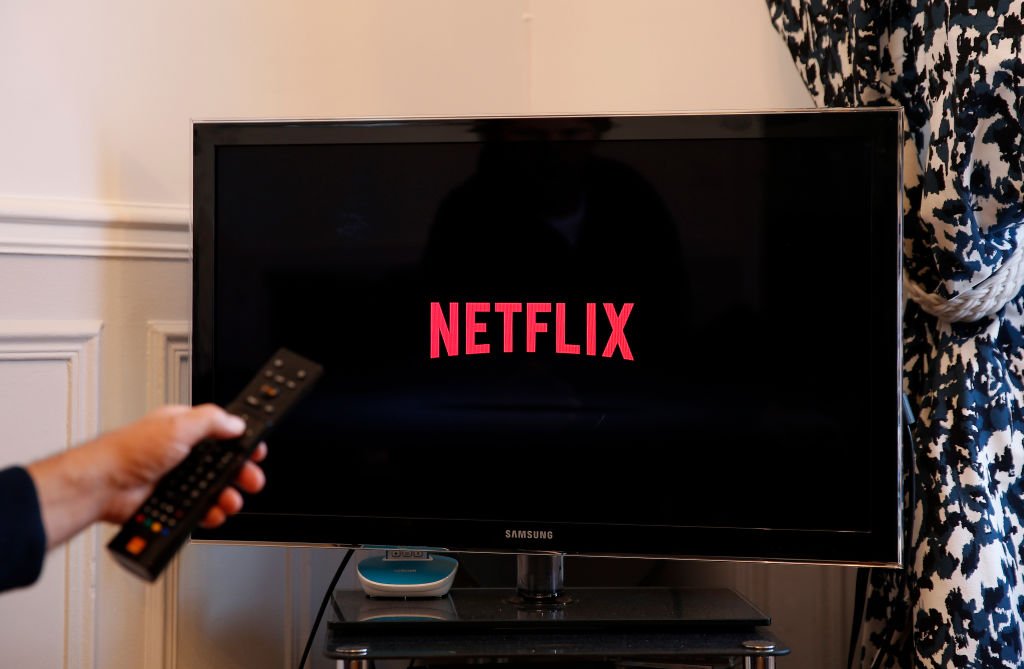 Image Credits: Getty Images / Illustration by Chesnot | In this photo illustration, the Netflix media service provider's logo is displayed on the screen of a television on October 23, 2018 in Paris, France.