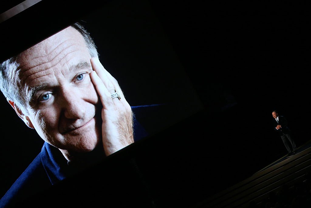 Image Credits: Getty Images / Mark Davis / NBC / NBCUniversal | An image of the late Robin Williams appears while actor/comedian Billy Crystal speaks on stage during the 66th Annual Primetime Emmy Awards held at the Nokia Theater on August 25, 2014. Image Credits: Getty Images / Mark Davis / NBC / NBCUniversal | An image of the late Robin Williams appears while actor/comedian Billy Crystal speaks on stage during the 66th Annual Primetime Emmy Awards held at the Nokia Theater on August 25, 2014.