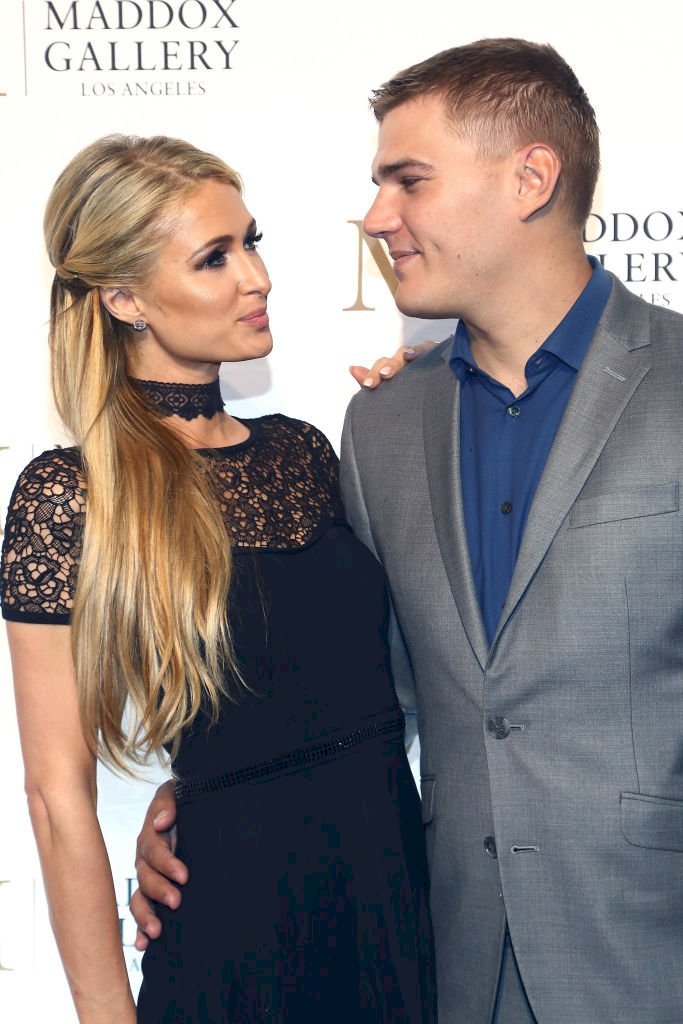 Image Credits: Getty Images / Tommaso Boddi | Paris Hilton and Chris Zylka attend the Grand Opening Maddox Gallery Los Angeles on October 11, 2018 in West Hollywood, California.
