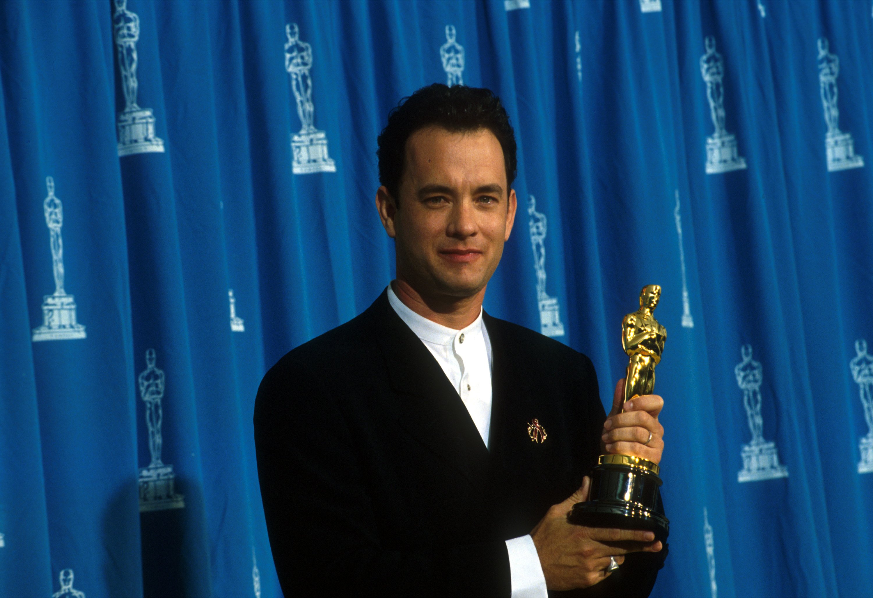 Image Credits: Getty Images / John Barr / Liaison | Actor Tom Hanks receives his Oscar at the Academy Awards in Los Angeles, CA., March 29, 1995.