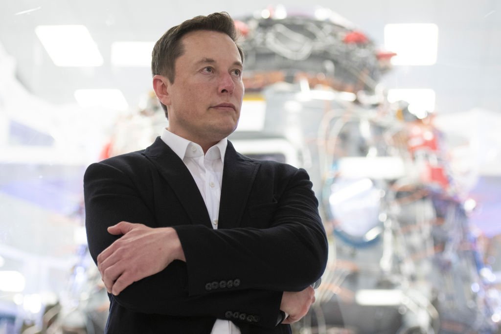 Image Credit: Getty Images / SpaceX Chief Engineer Elon Musk speaks in front of Crew Dragon cleanroom at SpaceX Headquarters in Hawthorne, California on October 10, 2019.