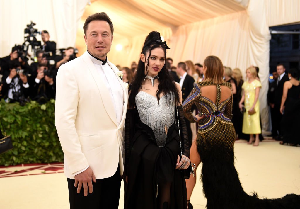 Image Credit: Getty Images / Elon Musk and Grimes attend the Heavenly Bodies: Fashion & The Catholic Imagination Costume Institute Gala at The Metropolitan Museum of Art on May 7, 2018 in New York City.
