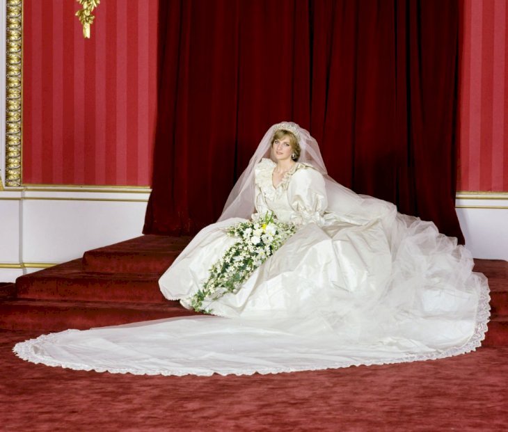 Image Credit: Getty Images/Lichfield Archive via Getty Images | Princess Diana poses with in her wedding dress
