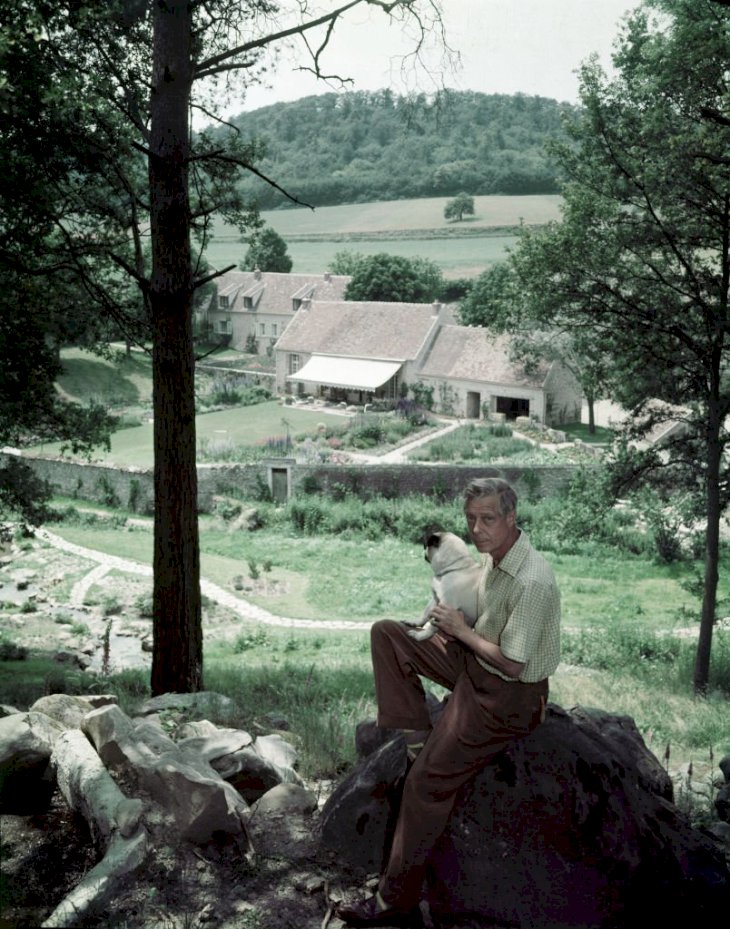 Image Credits: Getty Images / Frank Scherschel / The LIFE Picture Collection | Photograph of Edward VIII, the Duke of Windor (1894 - 1972), as he sits on a large rock on a hillside above his home, la Moulin de la Tuilerie, outside of Paris, France, 1955.