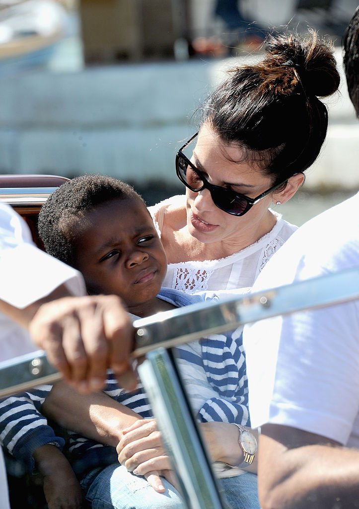 Image Credits: Getty Images / Jacopo Raule / FilmMagic | Actress Sandra Bullock (R) and son Louis Bardo Bullock is seen during the 70th Venice International Film Festival on August 27, 2013 in Venice, Italy.