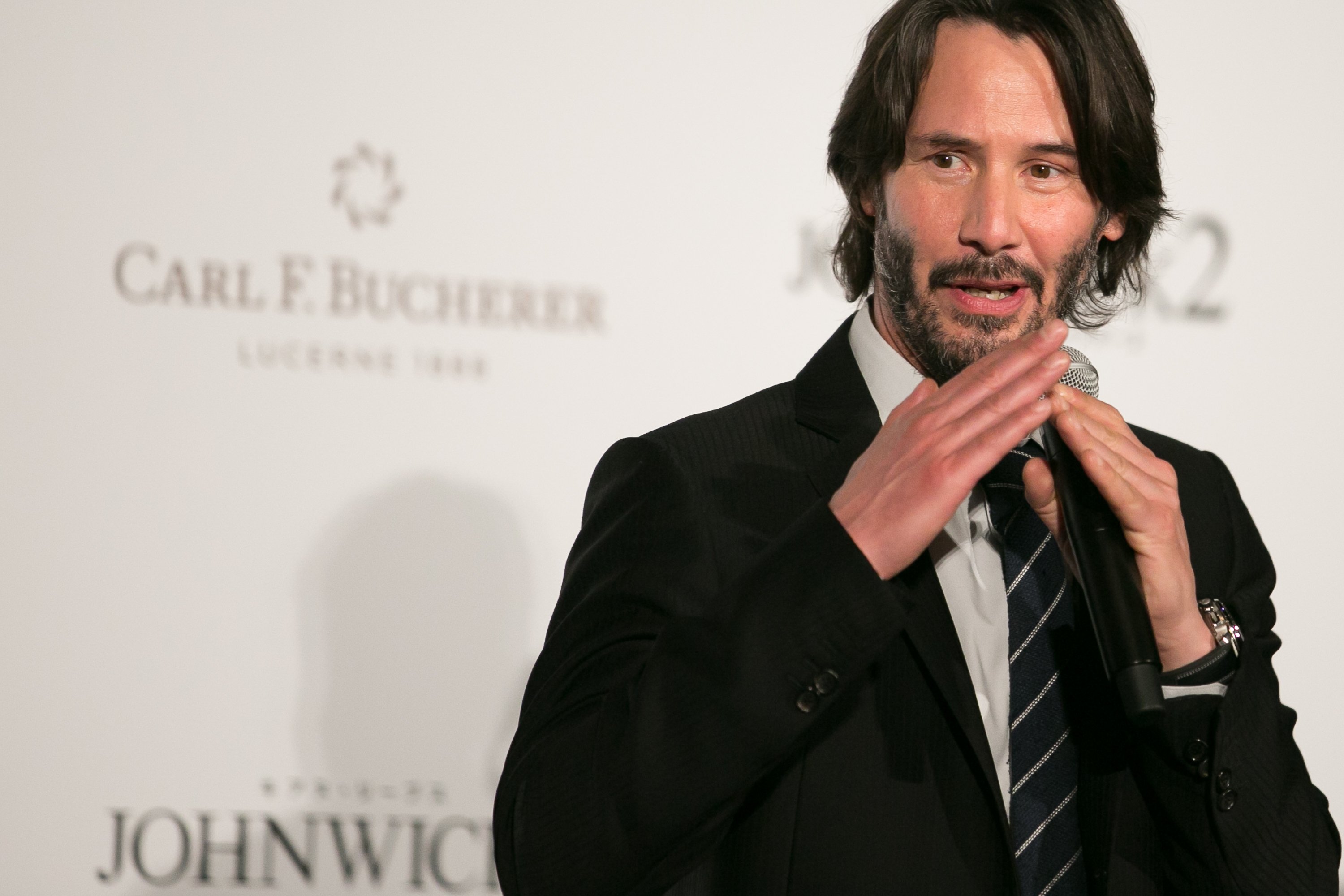 Image Source: Getty Images/Keanu speaking at a John Wick movie event