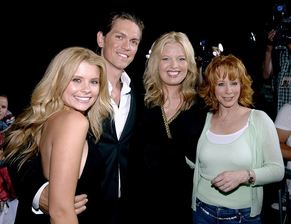 Image Credit: Getty Images / "Supercross" Los Angeles Premiere - Red Carpet Joanna Garcia, Steve Howey, Melissa Peterman and Reba McEntire.