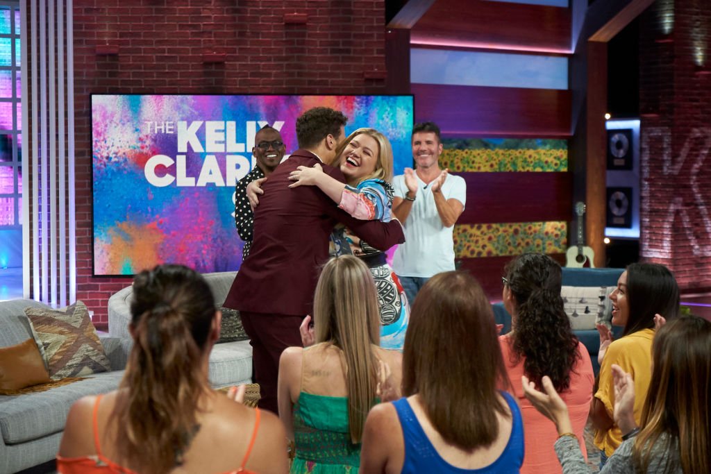 Image Credit: Getty Images / Randy Jackson, Justin Guarini, Kelly Clarkson, Simon Cowell on set for The Kelly Clarkson Show. Image Credit: Getty Images / Randy Jackson, Justin Guarini, Kelly Clarkson, Simon Cowell on set for The Kelly Clarkson Show.