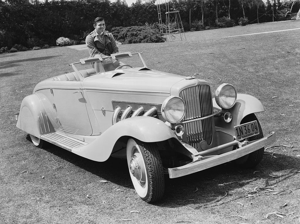 Image Credit: Getty Images / American screen star Clark Gable known as the 'King of Hollywood', poses in his custom-bodied Duesenberg J roadster. Image Credit: Getty Images / American screen star Clark Gable known as the 'King of Hollywood', poses in his custom-bodied Duesenberg J roadster.