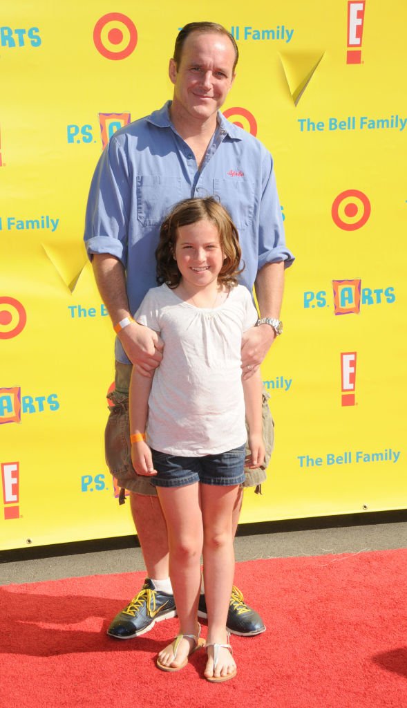Image Credits: Getty Images / Gregg DeGuire / FilmMagic | Clark Gregg and daughter Stella arrive at the Creative Arts Fair Supporting P.S. Arts at Barker Hangar at the Santa Monica Airport on November 7, 2010 in Santa Monica, California.