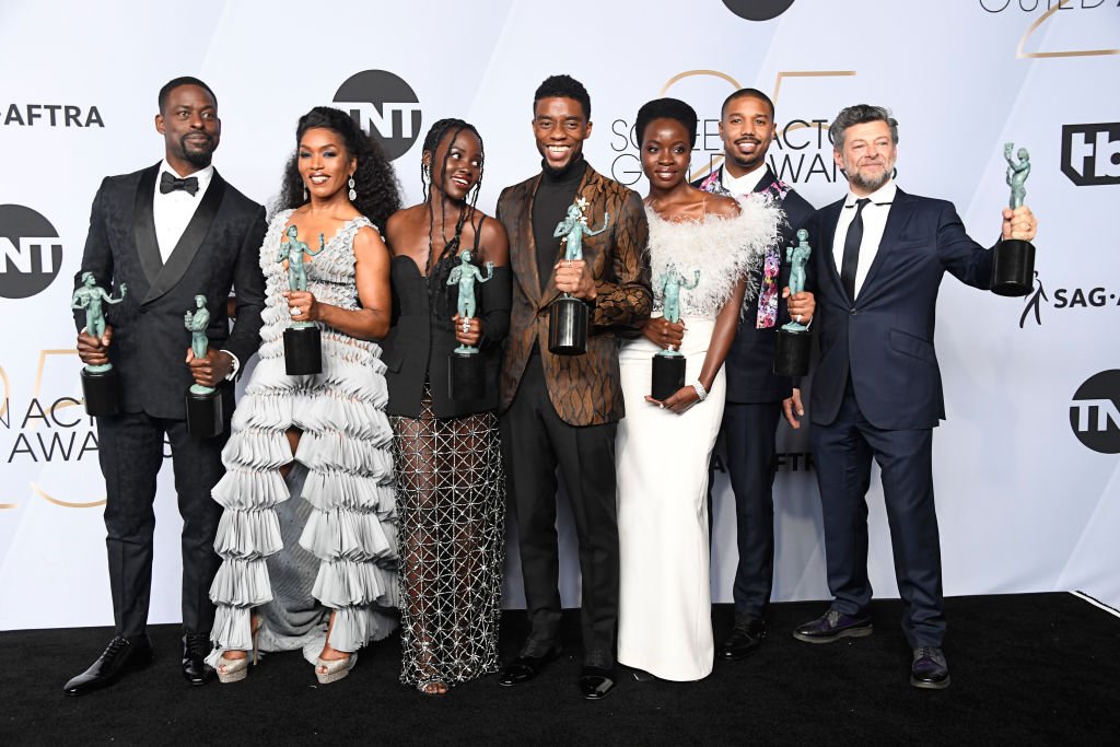 Image Credits: Getty Images / Frazer Harrison | (L-R) Sterling K. Brown, winner of Outstanding Performance by a Cast in a Motion Picture for 'Black Panther' and Outstanding Performance by an Ensemble in a Drama Series for 'This Is Us;' Angela Bassett, Lupita Nyong'o, Chadwick Boseman, Danai Gurira, Michael B. Jordan, and Andy Serkis, winners of Outstanding Performance by a Cast in a Motion Picture for 'Black Panther,' pose in the press room during the 25th Annual Screen Actors Guild Awards at The Shrine Auditorium on January 27, 2019 in Los Angeles, California.