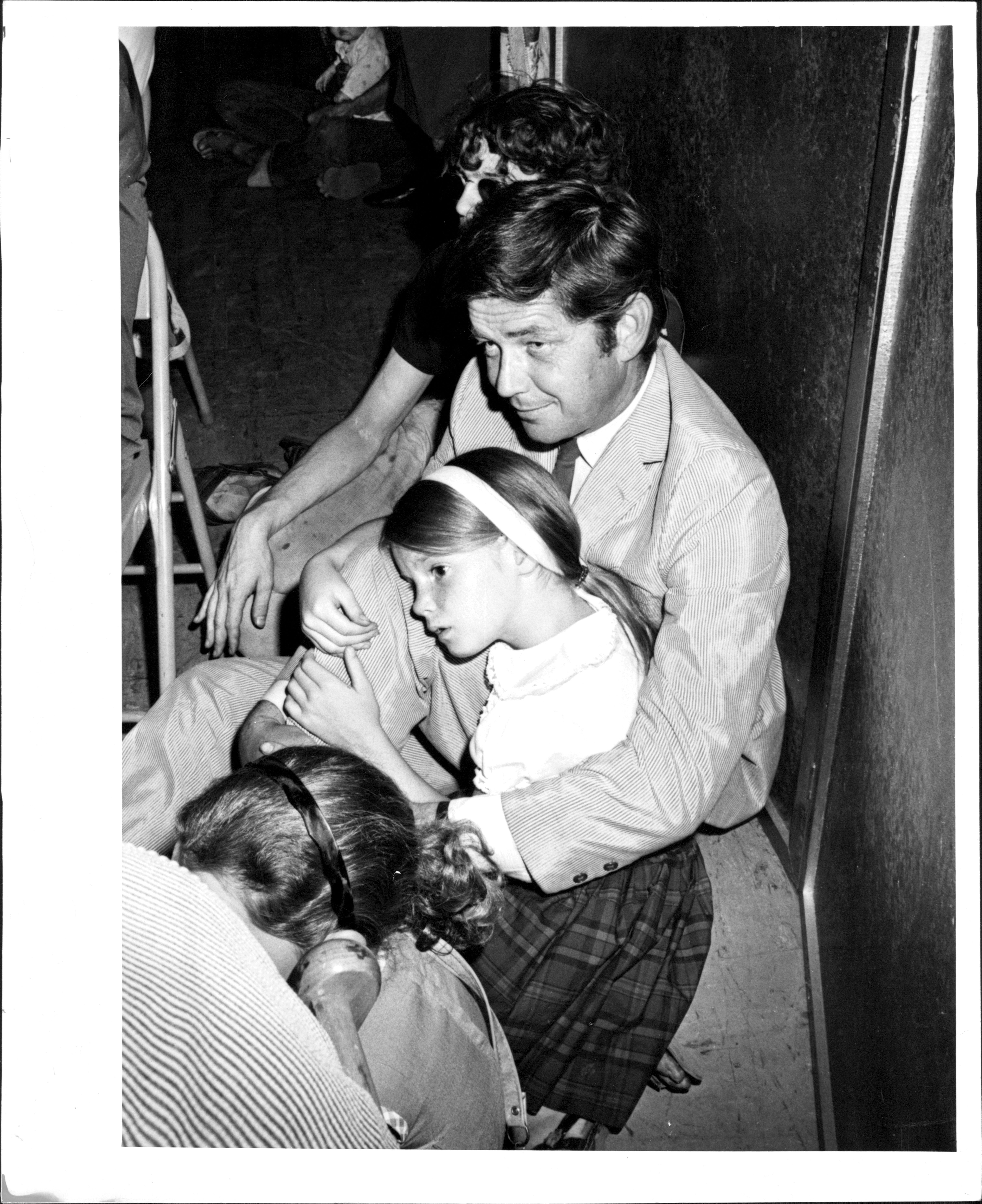 Image Credits: Getty Images / Jerry Engel | Ralph Waite, holding his daughter Kathleen, 9, was among those who attended services for Lenny Bruce at the Judson Memorial Church on Washington Square last night. August 13, 1966.