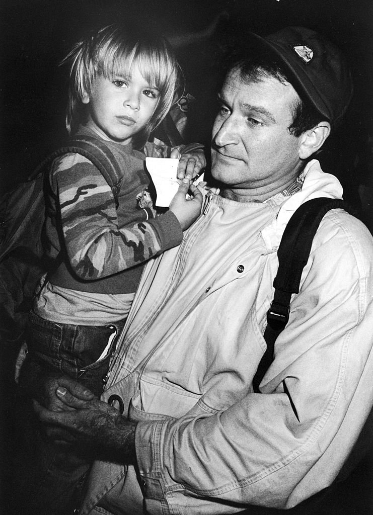 Image Credits: Getty Images / Kevin Winter / DMI / The LIFE Picture Collection | American comedian Robin Williams holds his son Zachary at the Comic Relief '87 charity event, Los Angeles, California, Novemeber 14, 1987. Image Credits: Getty Images / Kevin Winter / DMI / The LIFE Picture Collection | American comedian Robin Williams holds his son Zachary at the Comic Relief '87 charity event, Los Angeles, California, Novemeber 14, 1987.