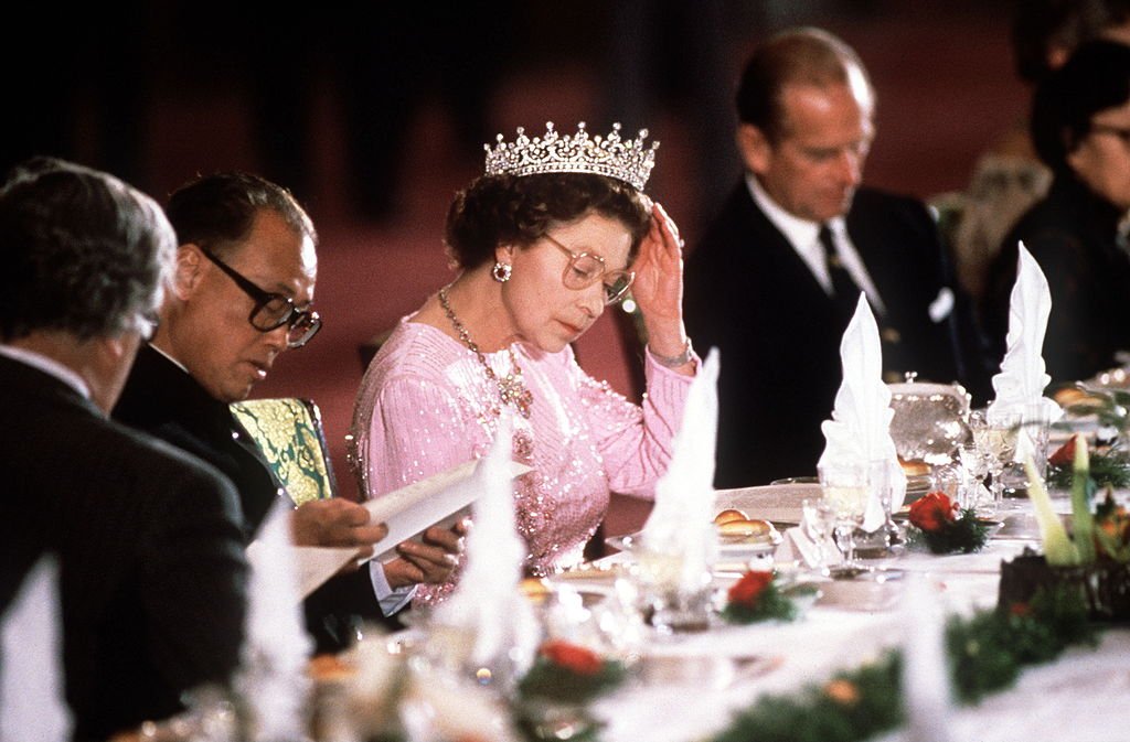 Image Credit: Getty Images / The Queen Adjusting Her Tiara During Her Visit With Prince Philip To Peking, China. Image Credit: Getty Images / The Queen Adjusting Her Tiara During Her Visit With Prince Philip To Peking, China.