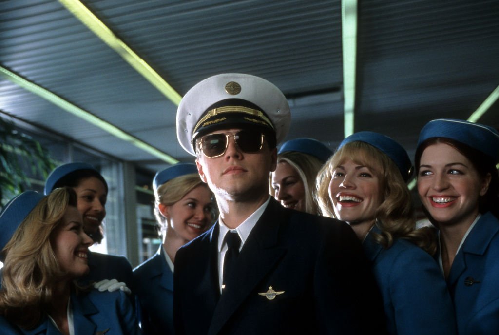 Image Source: Getty Images/Archive Photos| Leonardo DiCaprio with airline stewardess surrounding him in a scene from the film 'Catch Me If You Can', 2002