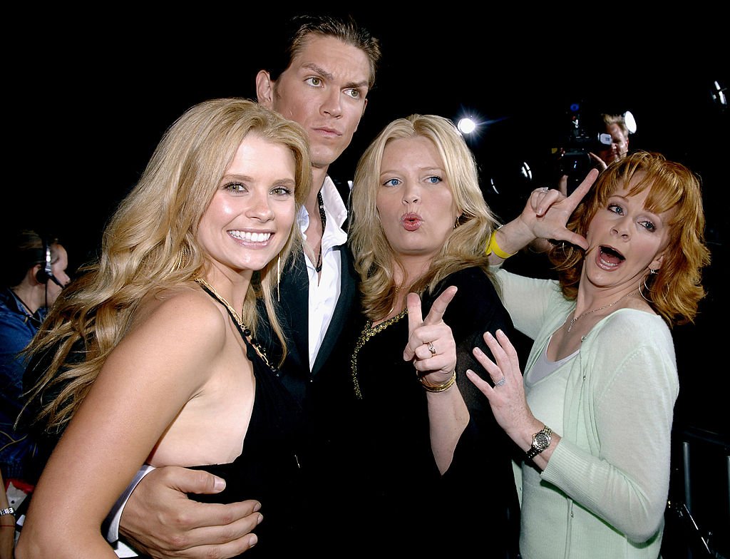 Image Credit: Getty Images / "Supercross" Los Angeles Premiere - Red Carpet Joanna Garcia, Steve Howey, Melissa Peterman and Reba McEntire.