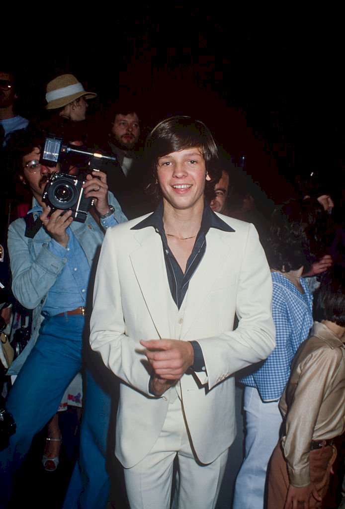 Image Credit: Getty Images / Jimmy McNichol in a white 3 piece suit and black shirt; circa 1970.