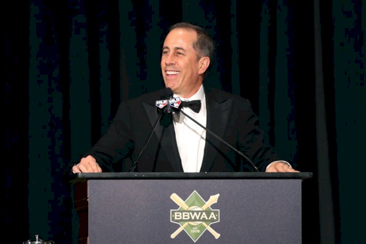 Image Credit: Getty Images / Jerry Seinfeld speaks to the crowd during the 2020 Baseball Writers' Association of America awards.