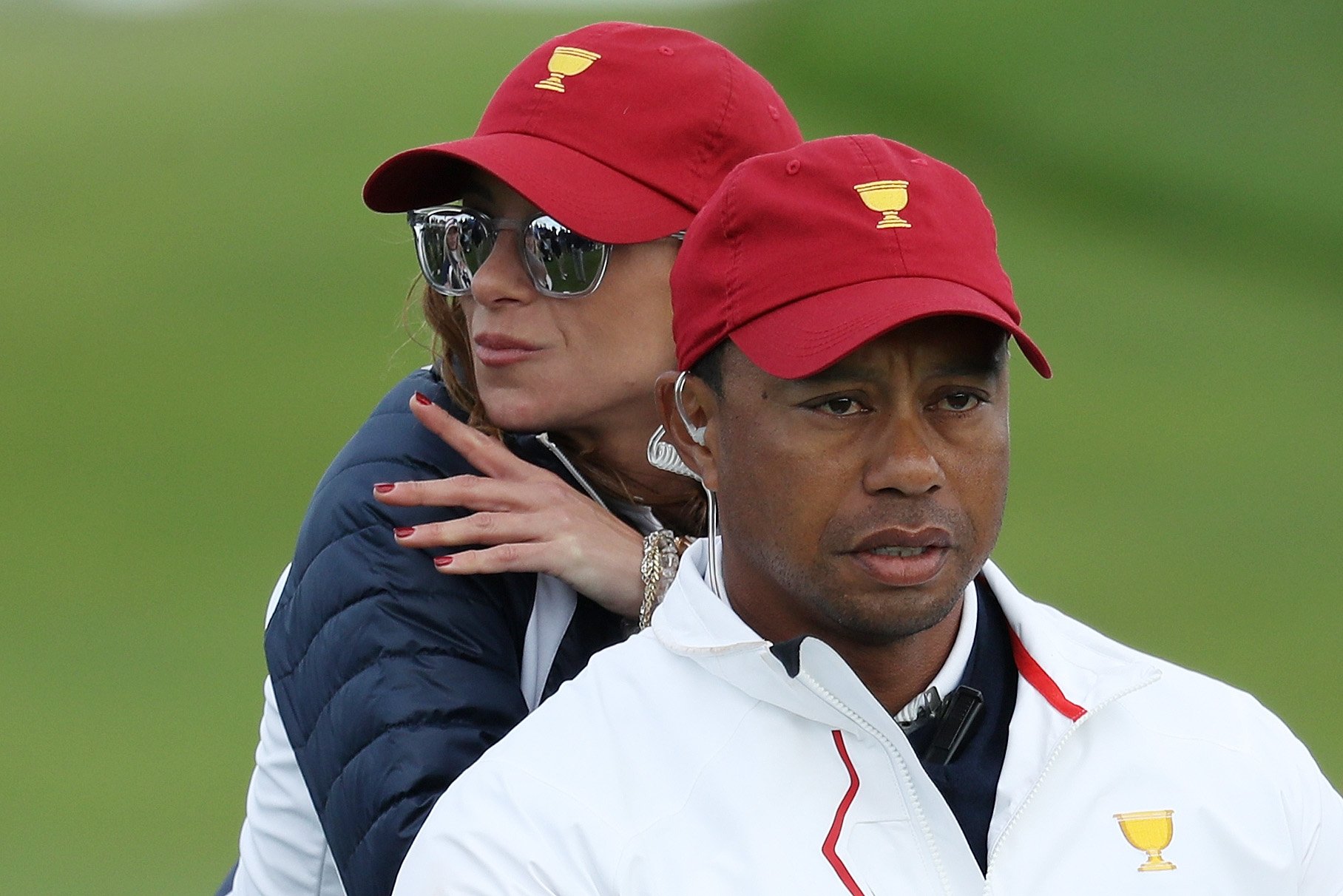 Image Credits: Getty Images / Rob Carr | Captain's assistant Tiger Woods of the U.S. Team and Erica Herman lok on during Saturday four-ball matches of the Presidents Cup at Liberty National Golf Club on September 30, 2017 in Jersey City, New Jersey. Image Credits: Getty Images / Rob Carr | Captain's assistant Tiger Woods of the U.S. Team and Erica Herman lok on during Saturday four-ball matches of the Presidents Cup at Liberty National Golf Club on September 30, 2017 in Jersey City, New Jersey.