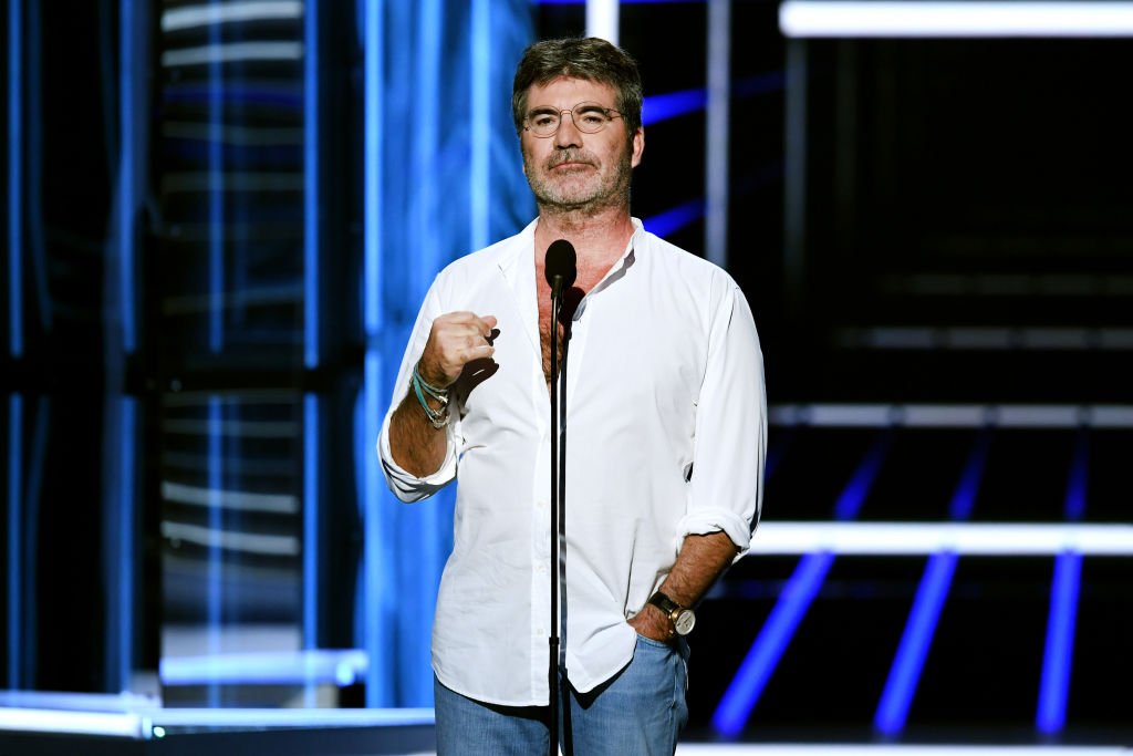 Image Credit: Getty Images / Producer-TV personality Simon Cowell speaks onstage during the 2018 Billboard Music Awards at MGM Grand Garden Arena on May 20, 2018 in Las Vegas, Nevada.