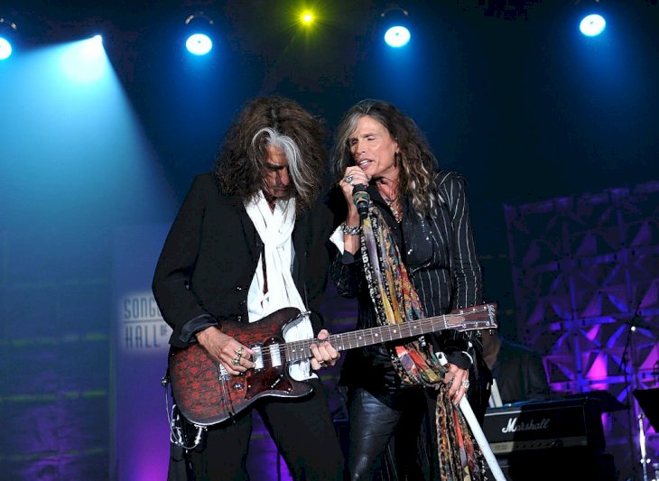 Image Credit: Getty Images / Steven Tyler performing on stage with Joe Perry.