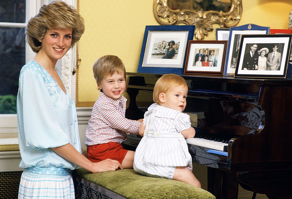 Image Credit: Getty Images / Diana, Princess of Wales with her sons, Prince William and Prince Harry, at the piano in Kensington Palace.