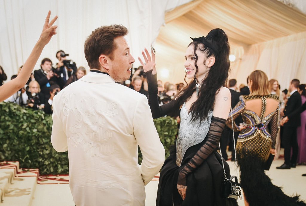 Image Credit: Getty Images / Elon Musk and Grimes attend the Heavenly Bodies: Fashion & The Catholic Imagination Costume Institute Gala at The Metropolitan Museum of Art on May 7, 2018 in New York City.