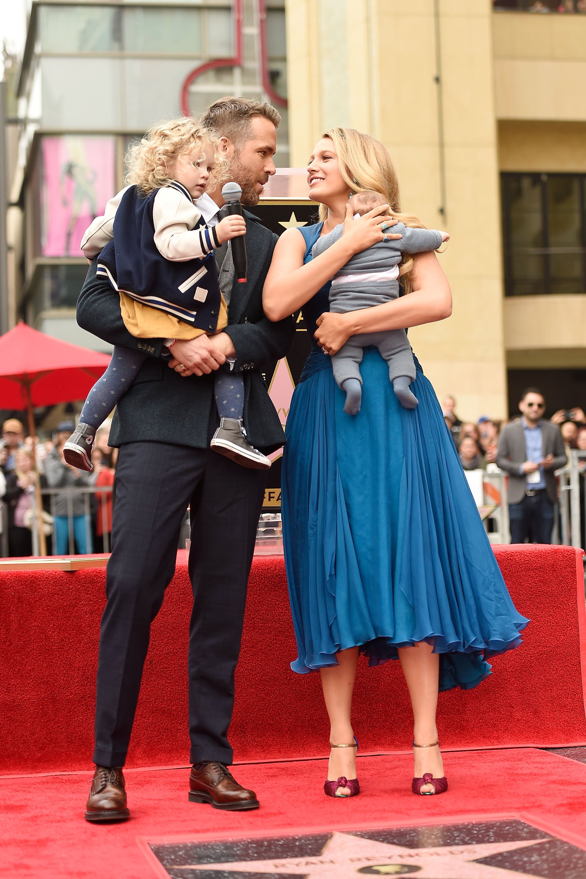 Image Credits: Getty Images / Matt Winkelmeyer | Actors Ryan Reynolds (L) and Blake Lively pose with their daughters as Ryan Reynolds is honored with star on the Hollywood Walk of Fame on December 15, 2016 in Hollywood, California.
