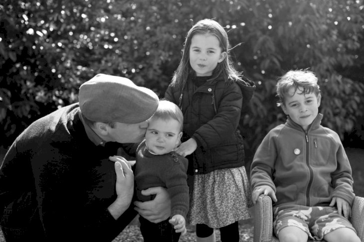 Image Credit: Getty Images / Prince William, Duke of Cambridge kisses Prince Louis as they pose next to Princess Charlotte and Prince George in Norfolk.