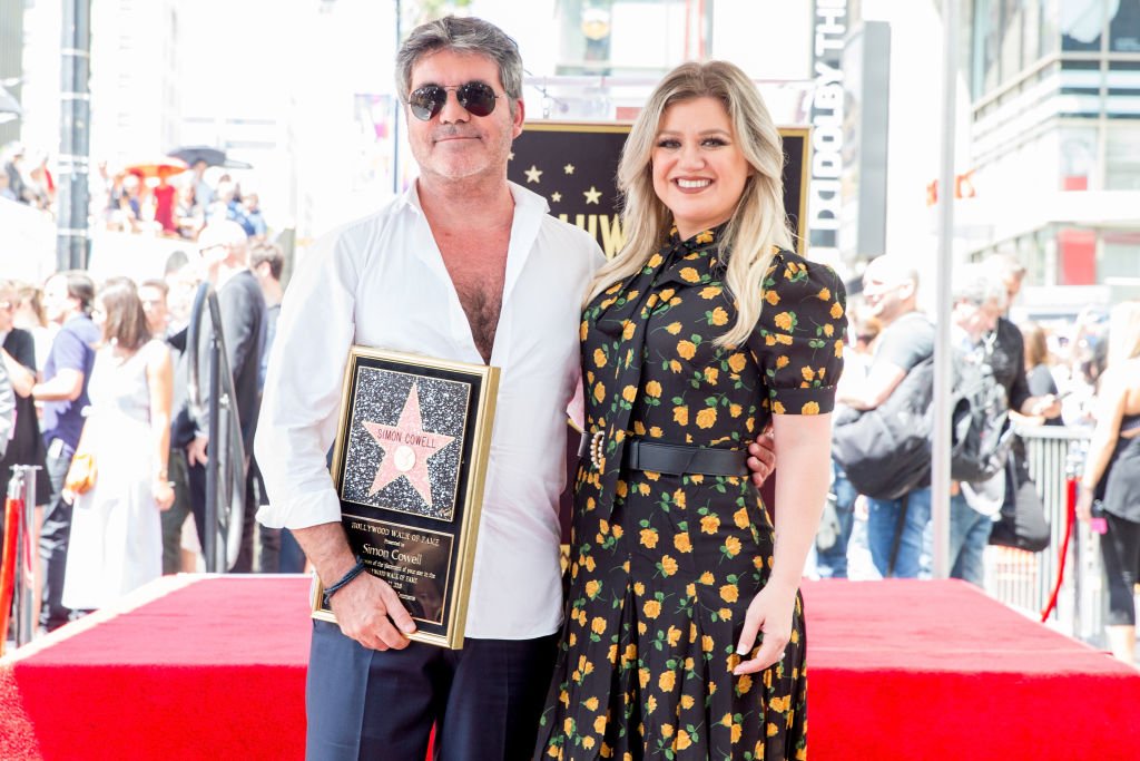 Image Credit: Getty Images / Simon Cowell (L) and Kelly Clarkson attend a ceremony honoring Cowell with a star on the Hollywood Walk of Fame on August 22, 2018.