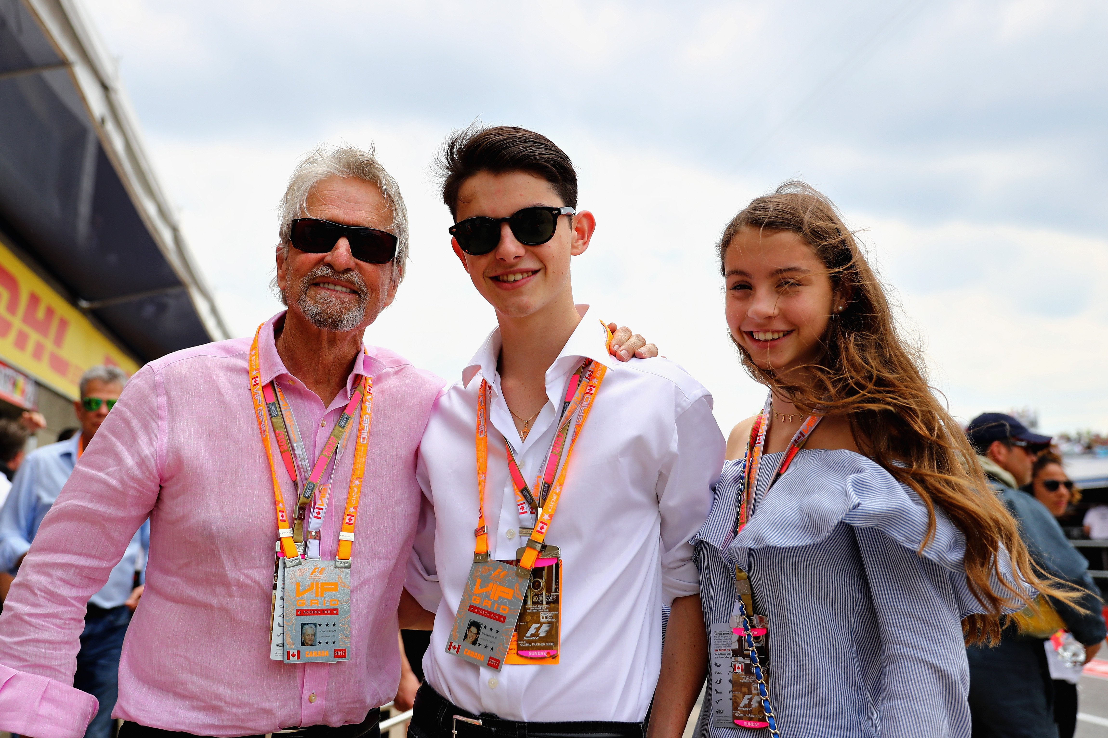 Image Credits: Getty Images / Clive Mason | Actor Michael Douglas with his children Dylan and Carys during the Canadian Formula One Grand Prix at Circuit Gilles Villeneuve on June 11, 2017 in Montreal, Canada.