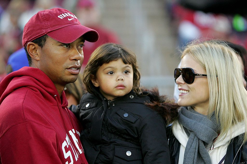 Image Credits: Getty Images / Ezra Shaw | Honorary Standford Cardinal captain Tiger Woods holds his daugher, Sam, and speaks to his wife, Elin Nordegren, on the sidelines before the Cardinal game against the California Bears at Stanford Stadium on November 21, 2009 in Palo Alto, California. Image Credits: Getty Images / Ezra Shaw | Honorary Standford Cardinal captain Tiger Woods holds his daugher, Sam, and speaks to his wife, Elin Nordegren, on the sidelines before the Cardinal game against the California Bears at Stanford Stadium on November 21, 2009 in Palo Alto, California.