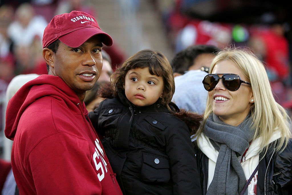 Image Credits: Getty Images / Ezra Shaw | Honorary Standford Cardinal captain Tiger Woods holds his daugher, Sam, and stands next to his wife, Elin Nordegren, on the sidelines before the Cardinal game against the California Bears at Stanford Stadium on November 21, 2009 in Palo Alto, California. Image Credits: Getty Images / Ezra Shaw | Honorary Standford Cardinal captain Tiger Woods holds his daugher, Sam, and stands next to his wife, Elin Nordegren, on the sidelines before the Cardinal game against the California Bears at Stanford Stadium on November 21, 2009 in Palo Alto, California.