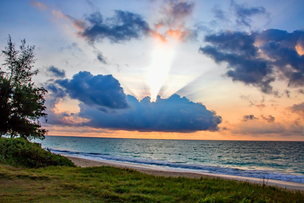 Sunrise behind thick clouds at Bellows Beach, Oahu, Hawaii | Shutterstock