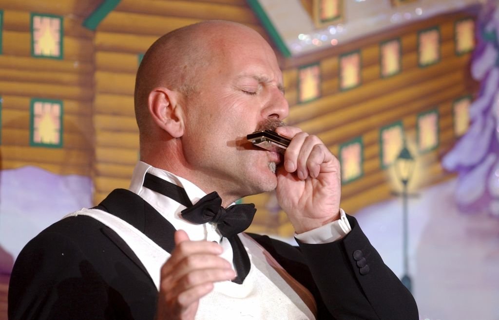 Image Credit: Getty Images / Harvard's Hasty Pudding Club's Man of the Year Bruce Willis plays harmonica before receiving the traditional pudding pot on stage at the Club. Image Credit: Getty Images / Harvard's Hasty Pudding Club's Man of the Year Bruce Willis plays harmonica before receiving the traditional pudding pot on stage at the Club.