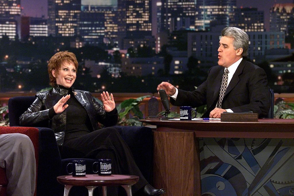 Image Credits: Getty Images / NBC/NBCU Photo Bank | Reba on The Tonight Show with Jay Leno in 1999