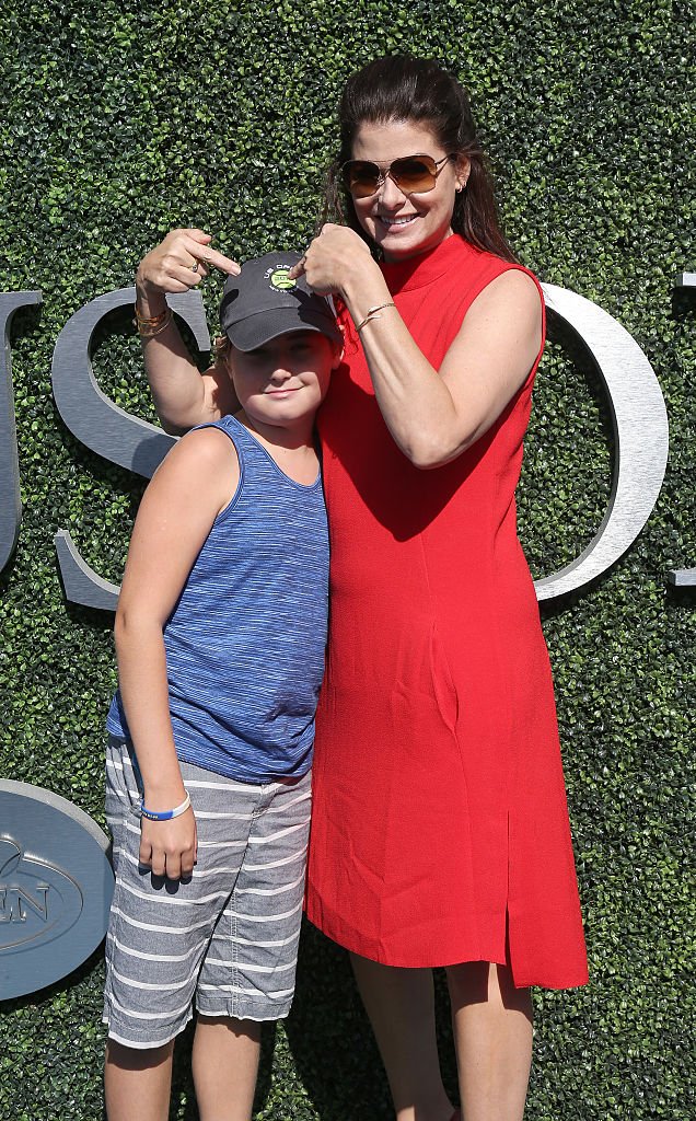 Image Source: Getty Images/Jean Catuffe| Debra Messing and her son Roman Zelman attend the men's final between Novak Djokovic of Serbia and Stan Wawrinka of Switzerland at Arthur Ashe Stadium