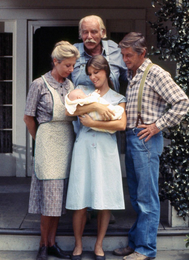 Image Credits: Getty Images / CBS | Michael Learned as Olivia Walton, Judy Norton as Mary Ellen Walton, Will Greer as Zeb Walton, and Ralph Waite as John Walton, in the CBS television series "The Waltons," circa 1977.