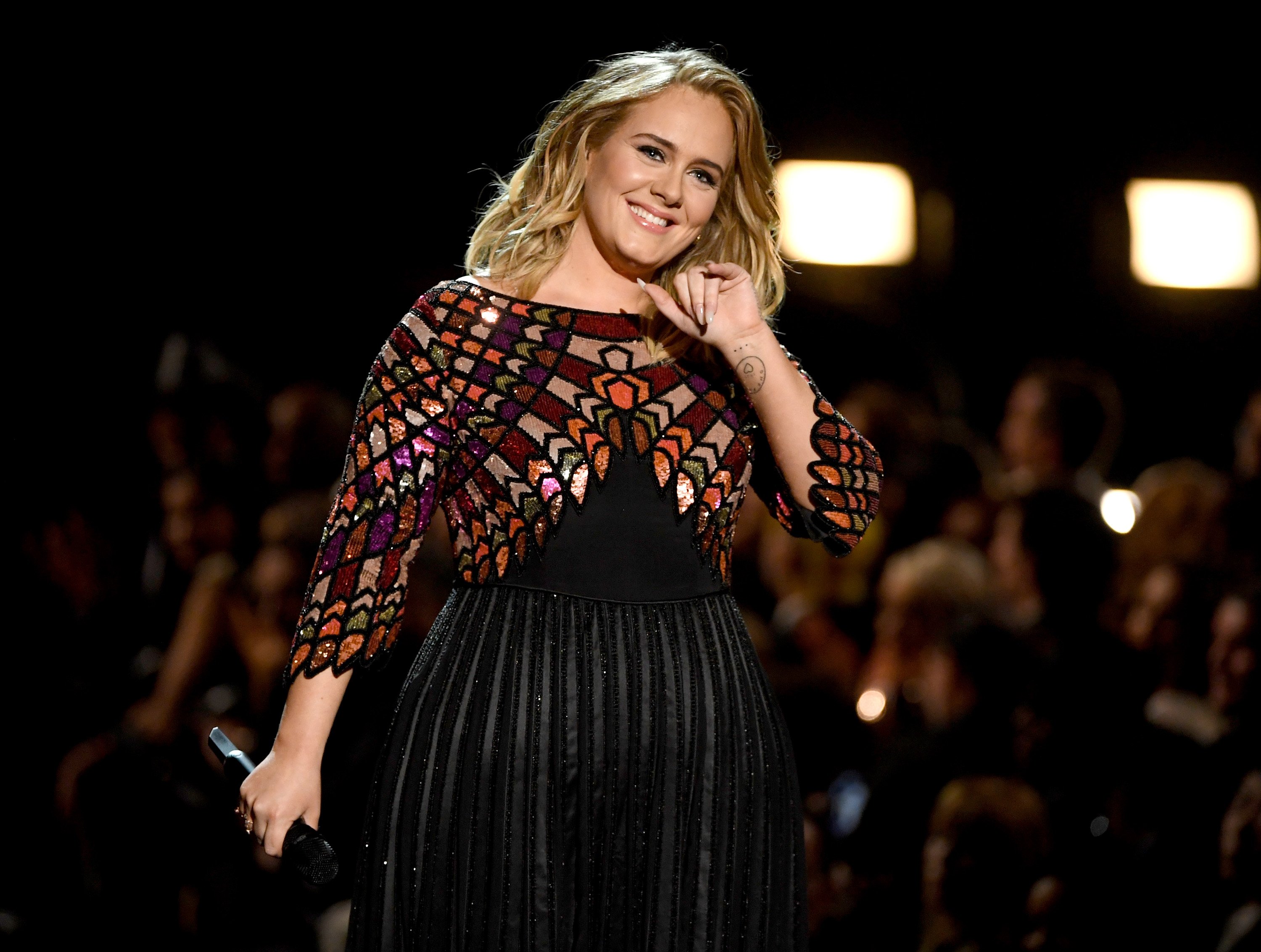 Image Credit: Getty Images / Adele performing at a concert. Image Credit: Getty Images / Adele performing at a concert.
