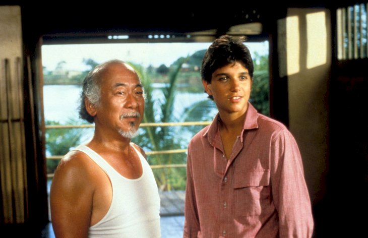 Pat Morita and Ralph Macchio in a scene from the film 'The Karate Kid' / Getty Images